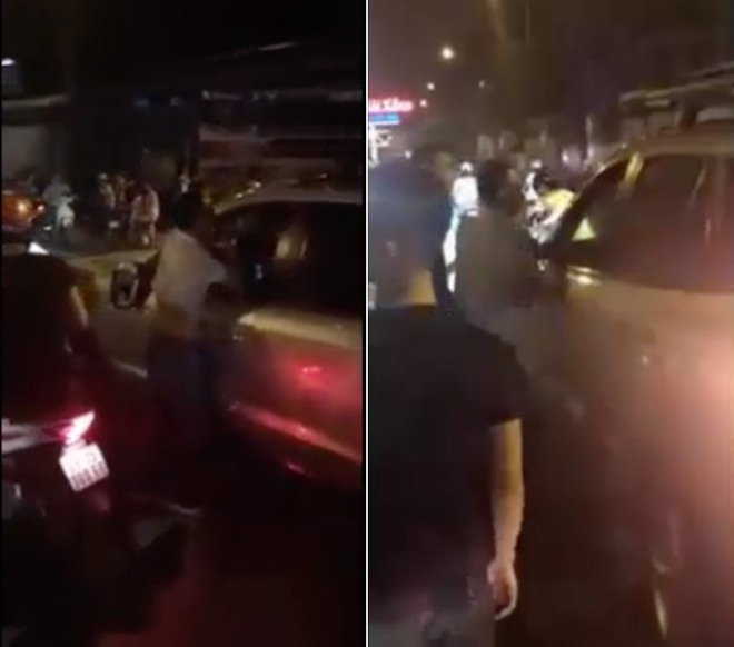 Người đàn ông bắt nạt taxi, bị dân quây liền cố thủ trong xe - Ảnh 1.