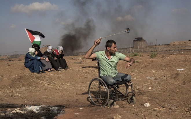 24h qua ảnh: Người biểu tình Palestine ngồi xe lăn quăng đá vào lính Israel - Ảnh 4.