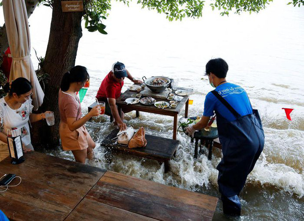 Nhà hàng “tranh thủ” nhất mùa lũ: Nước ngập quá đầu gối vẫn mở cửa, khách vừa ăn vừa “nhảy sóng” - Ảnh 3.