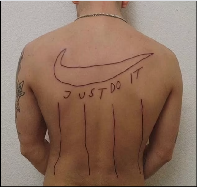 Nike Logo tattoo on the left side of the chest