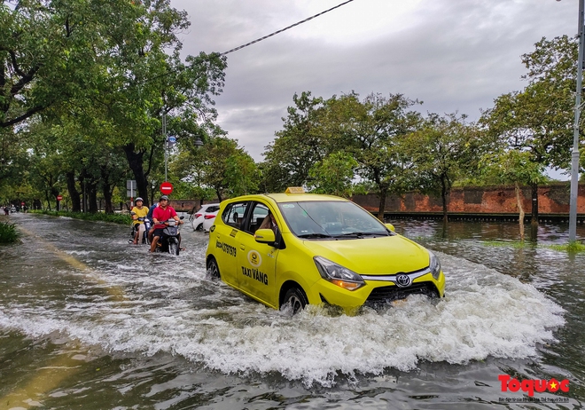  Khách Tây trải nghiệm đi thuyền giữa phố, người dân giăng lưới bắt cá bên Kinh thành Huế sau mưa  - Ảnh 2.