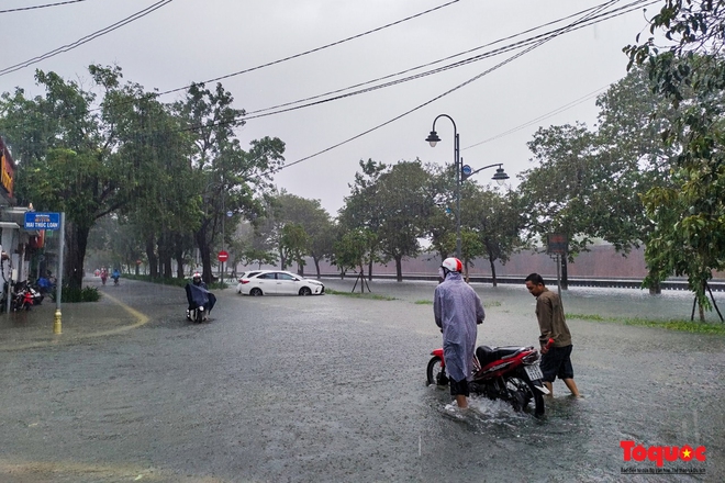  Khách Tây trải nghiệm đi thuyền giữa phố, người dân giăng lưới bắt cá bên Kinh thành Huế sau mưa  - Ảnh 1.