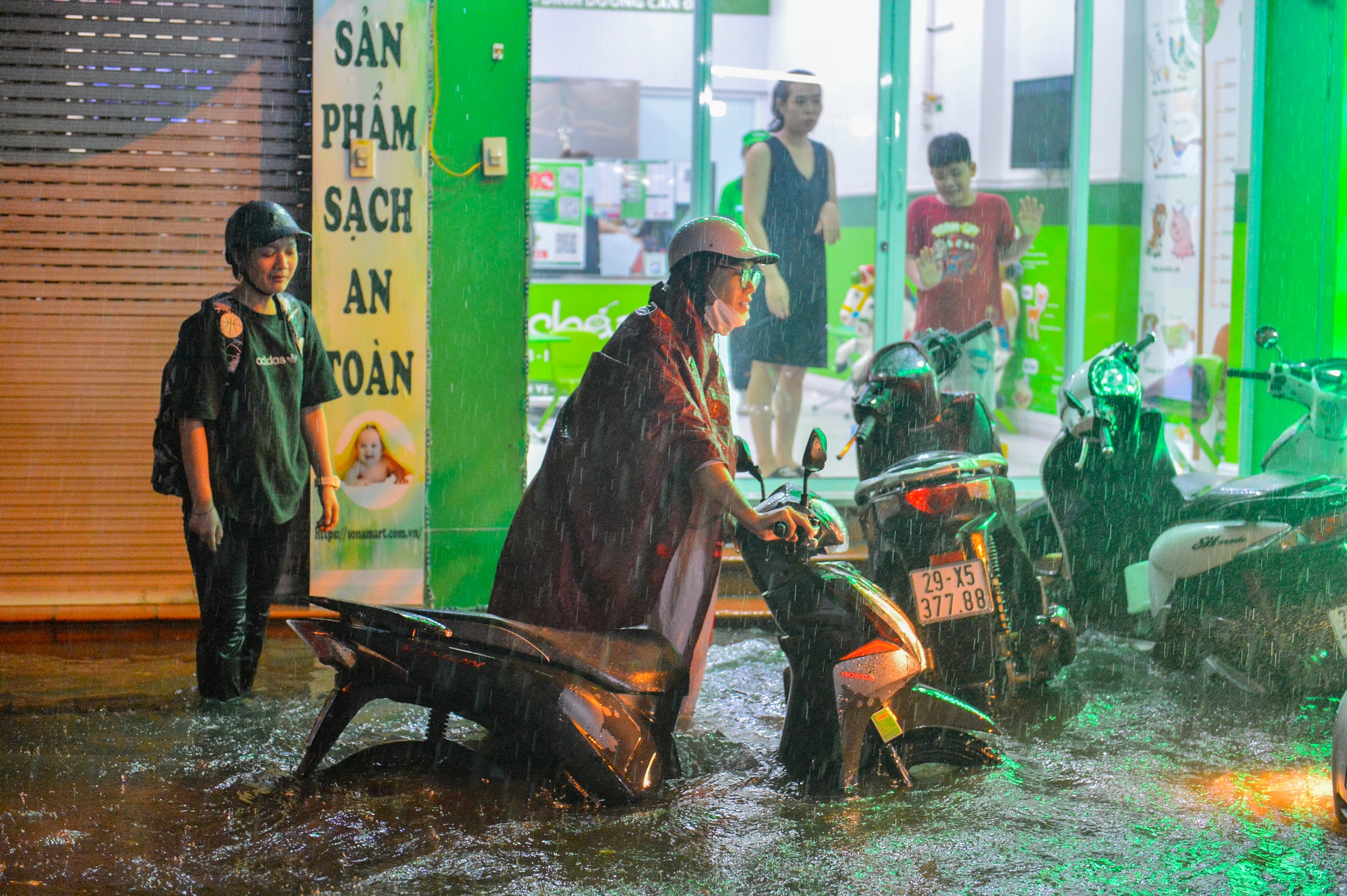 Mưa xối xả khiến đường Hà Nội chìm trong biển nước, sóng đánh đổ xe máy - Ảnh 3.