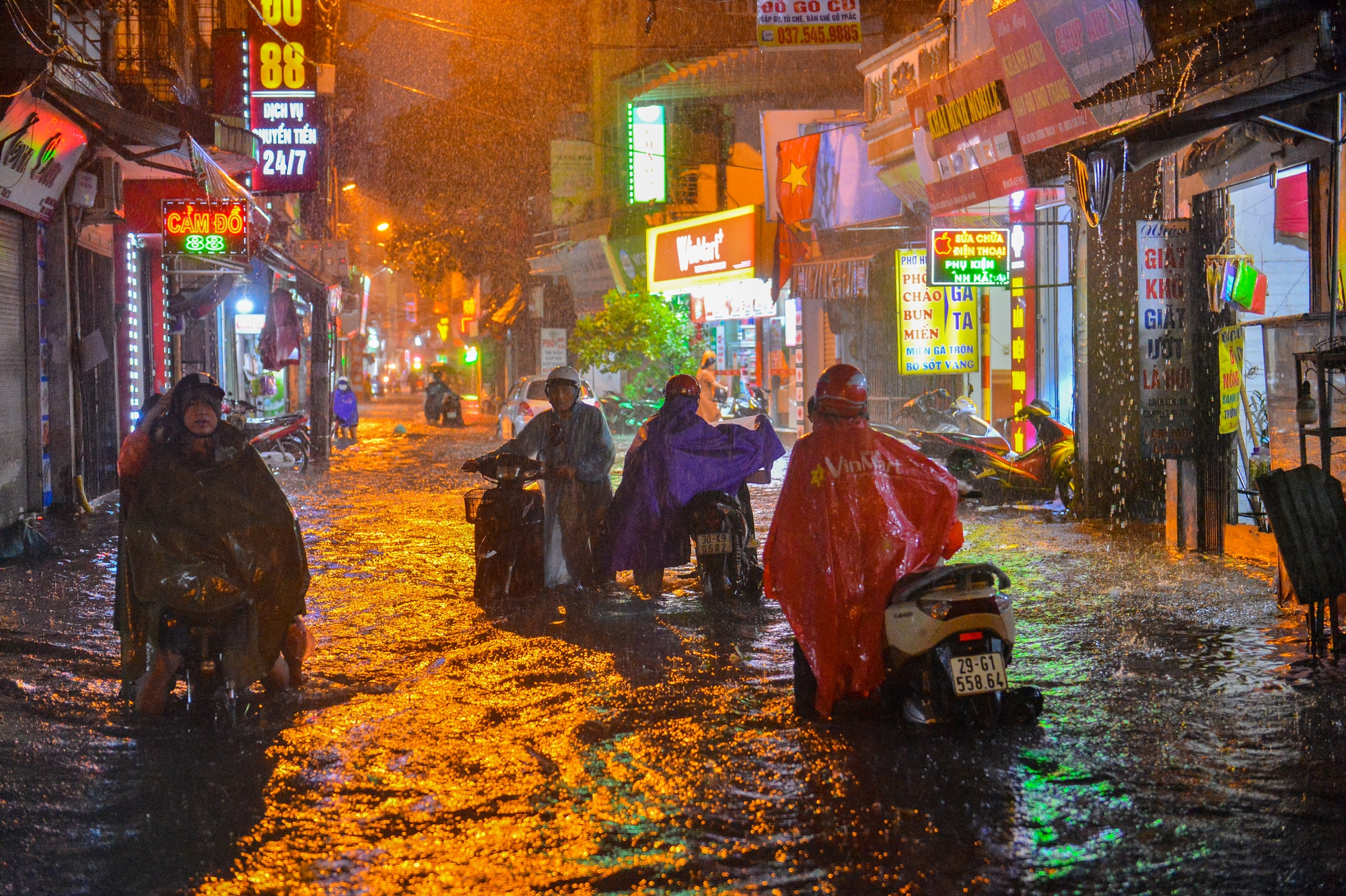 Mưa xối xả khiến đường Hà Nội chìm trong biển nước, sóng đánh đổ xe máy - Ảnh 4.