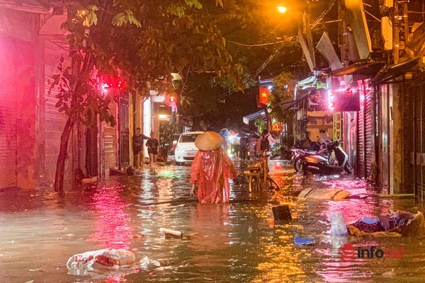 Hà Nội: Cơn mưa lớn kéo dài, nhiều tuyến phố ngập úng, người dân phải dùng xô tát nước ra khỏi nhà - Ảnh 7.