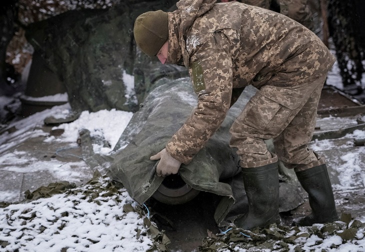 Một quân nhân Ukraine ngụy trang pháo tự hành gần Chasiv Yar ở vùng Donetsk. Ảnh: Reuters