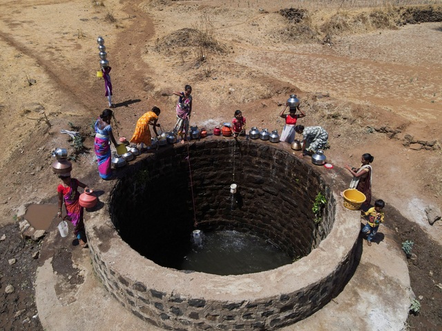 Người dân đi lấy nước từ một giếng công cộng hiếm hoi ở thị trấn Kasara, bang Maharashtra - Ấn Độ giữa nắng nóng hôm 1-5 Ảnh: REUTERS