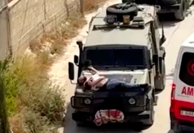 Mỹ ‘sốc’ với video người Palestine bị trói trên mũi xe quân sự Israel- Ảnh 1.