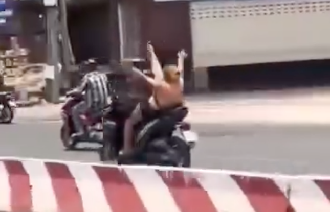 Danh tính người phụ nữ nhún nhảy khi lái xe máy - Ảnh 2.