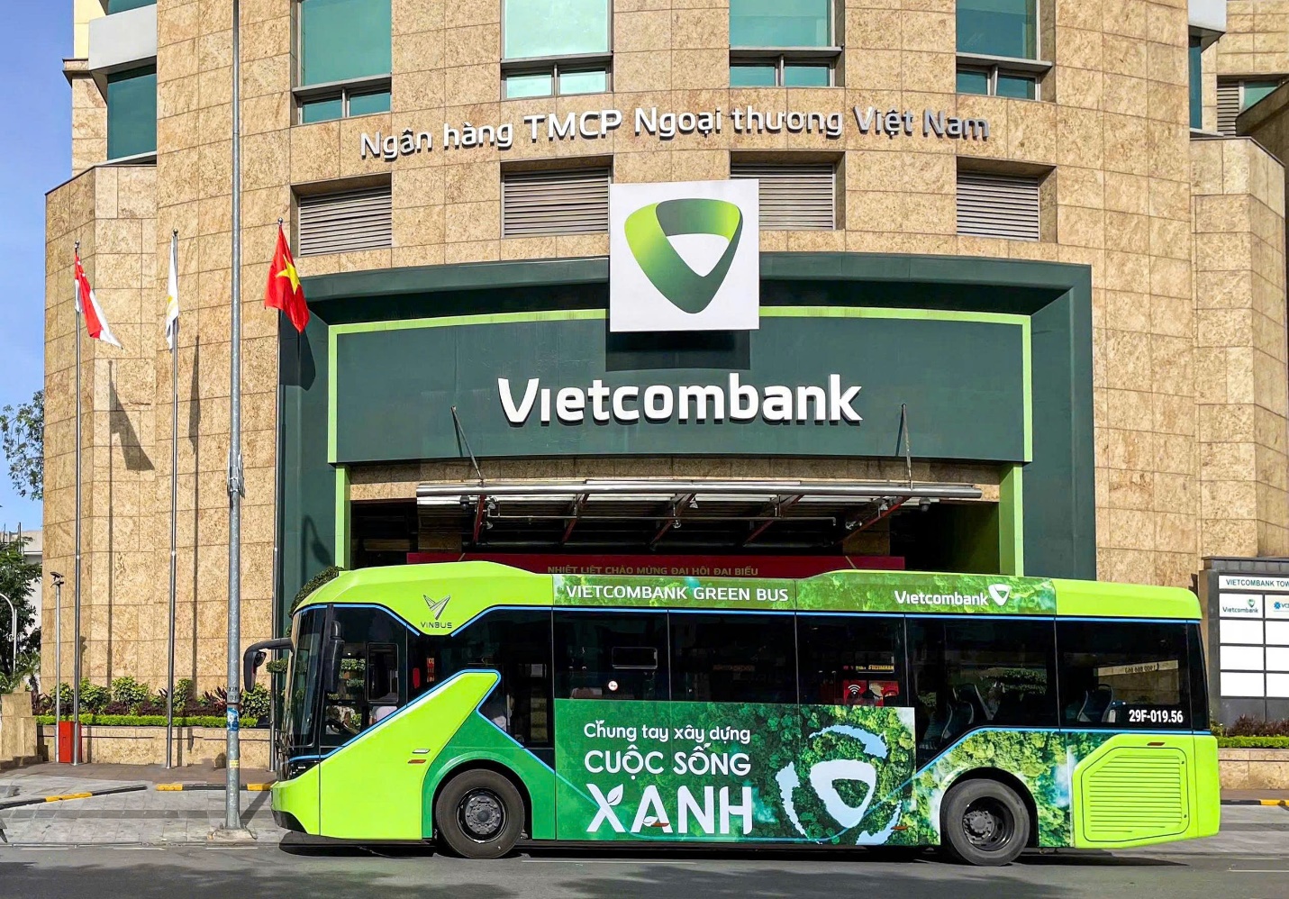 A green bus parked in front of a building AI-generated content may be incorrect.