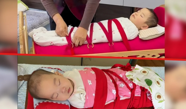 Kiểu nuôi con gây sốc: Trẻ sơ sinh bị buộc chặt trong nôi chứa cát để mô phỏng vòng tay mẹ- Ảnh 1.