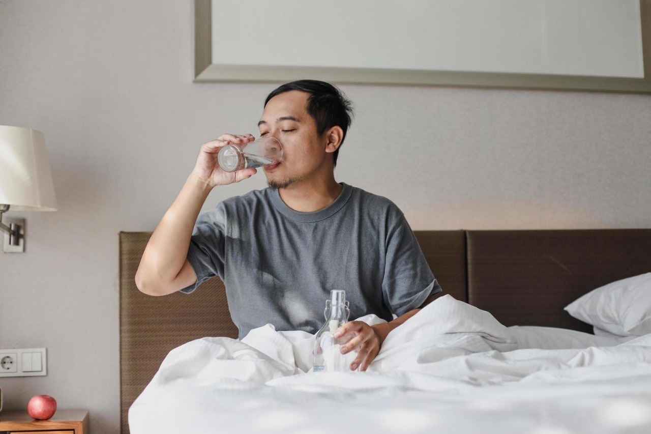 man sitting on the bed and drinking a glass of mineral water after wake up from sleep photo 162159 1776694845816 17766948461131595158449