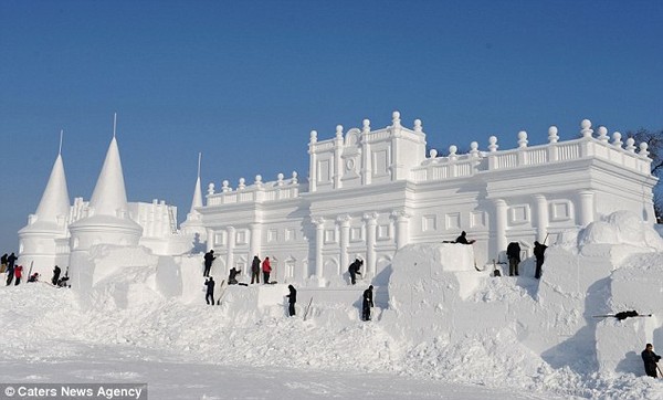 Ice palace: Workers shape a snow sculpture for the annual Jingyue Snow World festival in Jingyuetan National Forest in Chinas Jilin Province