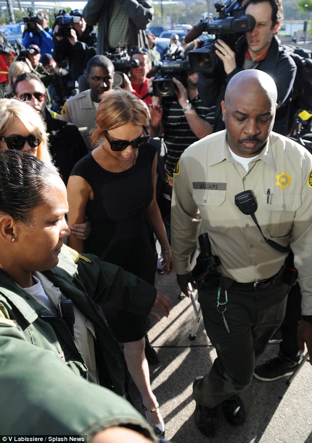 Media frenzy: Lohan was flanked by photographers as she was led into the court house