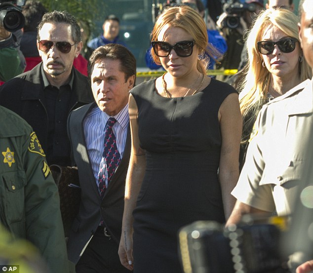 Making a sharp exit: The Mean Girls child star leaves the court, flanked by her mother Dina, right, lawyer Heller, left