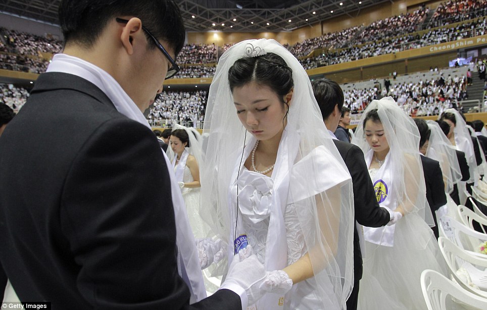 For better or for worse: The ceremony was presided over by Hak Ja-han - the widow of Sun Myung Moon, who died in September