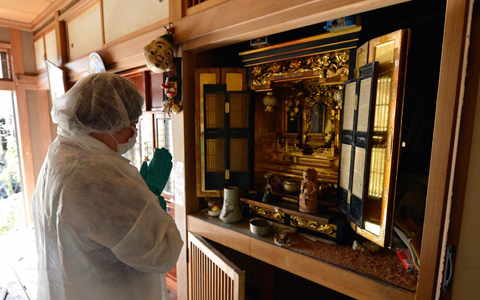 Yuko Mihara offers prayers to her ancestors in front of a family Buddhist altar. Residents are now waiting to receive compensation from the government and TEPCO, the operator of the crippled Fukushima Daiichi nuclear power plant. Two years have passed since the disaster and frustration is gaining ground in the community. Cloistered in small rooms at temporary housings, evacuees are living in total uncertainty about their future