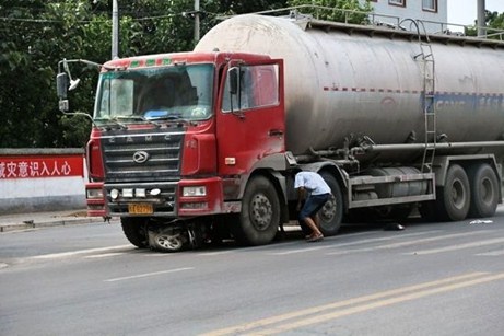 Trung Quốc: Người phụ nữ kẹt dưới gầm xe cầu xin tài xế ‘tha chết’