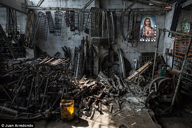 Icon: A painting of Sacred Heart of Jesus, the old name of the town, hangs in a workshop