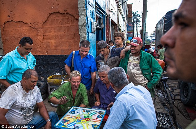Down time: Workers play parqu during an afternoon break