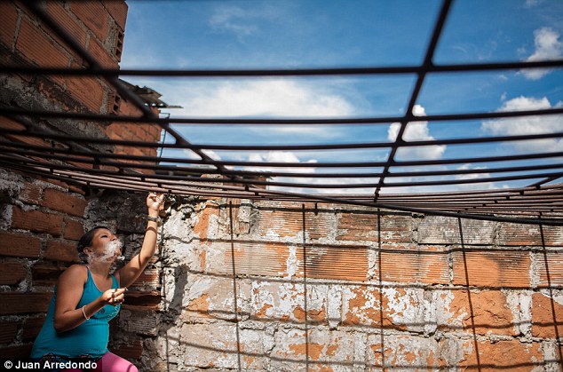 Trapped: A pregnant woman smokes marijuana from the back yard of a repair shop