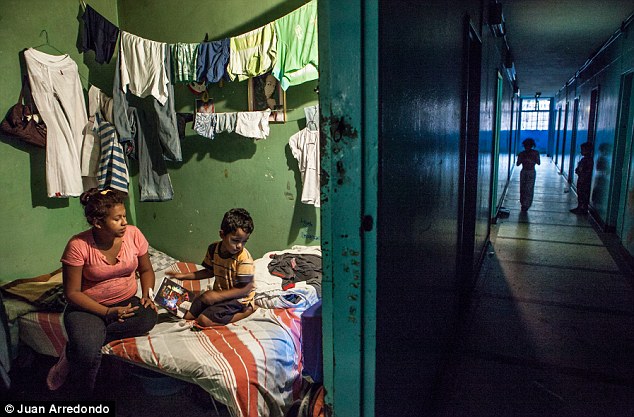 Crowded: Laundry hangs over the bed in a tiny room shared by this family