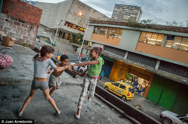 Youthful: Despite the despair, children still play happily on a rooftop