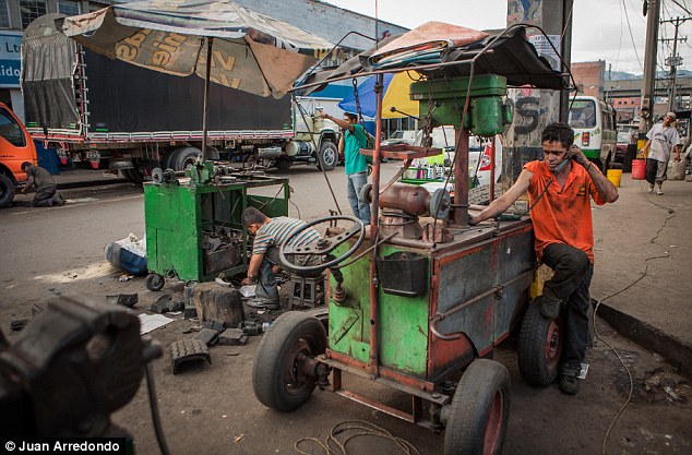 Grime: Workers repair vending carts on the street