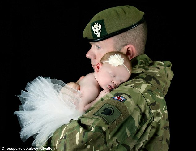 Winner: This picture of L/Cpl Kevin McCarthy with his daughter Marni, just eight days old at the time, has won a competition run by charity My Daddy is a Soldier Adventures