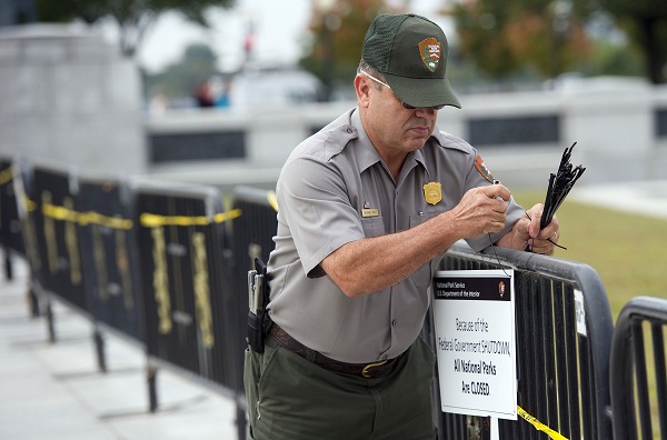 	Một nhân viên gắn biển đóng cửa trên rào chắn trước cửa Đài tưởng niệm Lincoln.