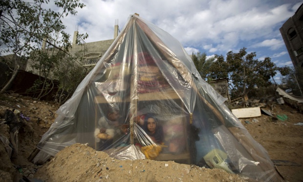 Một gia đình người Palestine ngồi trong túp lều tạm sau khi ngôi nhà của họ bị ngập sau trận bão lớn ở dải Gaza.