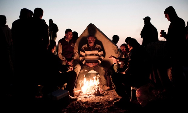 Những người Palestin sưởi ấm quanh một đống lửa ở ngoại ô Bờ Tây.