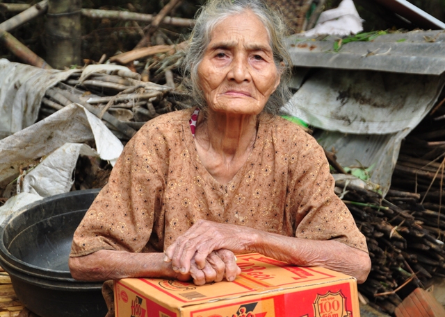 
	Bà Lê Thị Thôi (81 tuổi) ở Quảng Ngãi bên thùng mì cứu trợ.