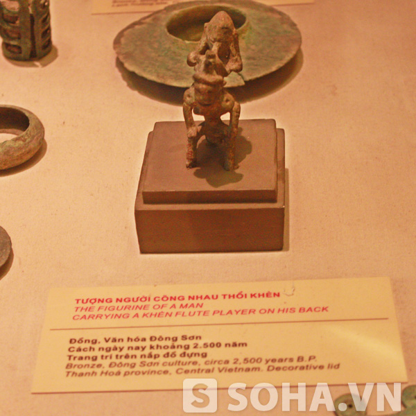 Cây đèn hình người quỳ cũng được phát hiện bởi nhà khảo cổ học O.Janse (Thụy Điển) khi đang khai quật ngôi mộ gạch và chuyển về Bảo tàng năm 1935. Đây là hiện vật rất độc đáo trong số ít những cây đèn cùng loại thuộc thời kỳ Hậu Đông Sơn, phản ánh sự giao thoa giữa văn hóa Đông Sơn với các nền văn hóa khác. Cây đèn với hình khối tạo tác và hoa văn trang trí, thể hiện tài năng nghệ thuật cũng như tư duy thẩm mỹ và khả năng tiếp nhận, thích ứng của người Việt cổ hàng ngàn năm trước.