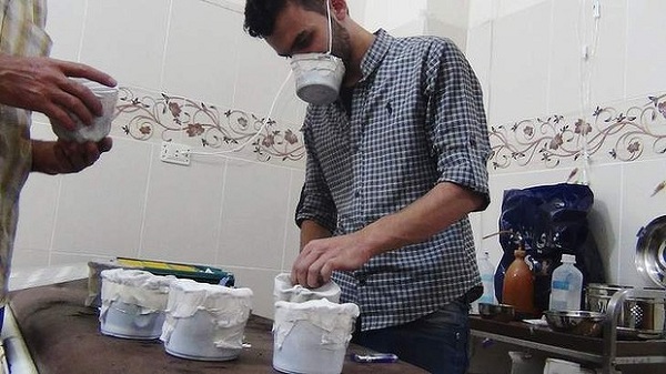 	Một người đàn ông đang tự chế mặt nạ phòng khí độc tại ngoại ô Damacus.