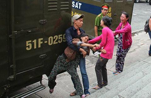 Bà Út và Khánh Minh (áo đỏ) gào thét bên xe tù chở Hồ Duy Trúc sau phiên tòa sơ thẩm