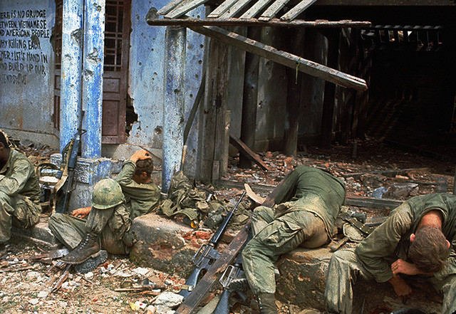 13 Mar 1968, Quang Tri --- Exhausted GIs Rest in Front of a Ruin --- Image by © Bettmann/CORBIS