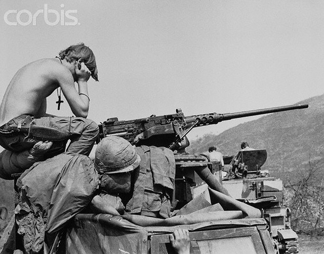 04 Apr 1971, Lang Vei, South Vietnam --- Lost In Thought? Lang Vei, S. Vietnam: Cross hanging from his neck, GI of the 1/5th Mechanized Division, sits atop his armored personnel carrier with head resting in hands. Lang Vei is the western-most American position near the Laotian border. --- Image by © Bettmann/CORBIS