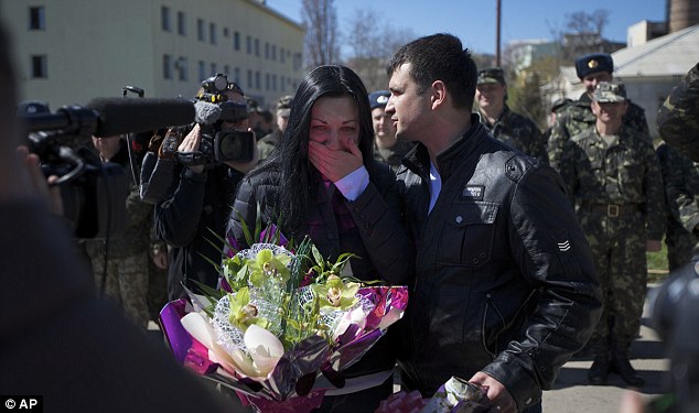 Wedding: Galina Volosyanchik, left, and Ivan Benera, right, are welcomed to the surrounded Belbek airbase by senior officers