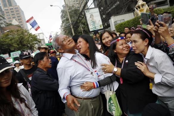 Lãnh đạo nhóm biểu tình chống chính phủ Suthep Thaugsuban được ôm bởi một người ủng hộ khi ông tuần hành trên đường phố ở Bangkok, Thái Lan.