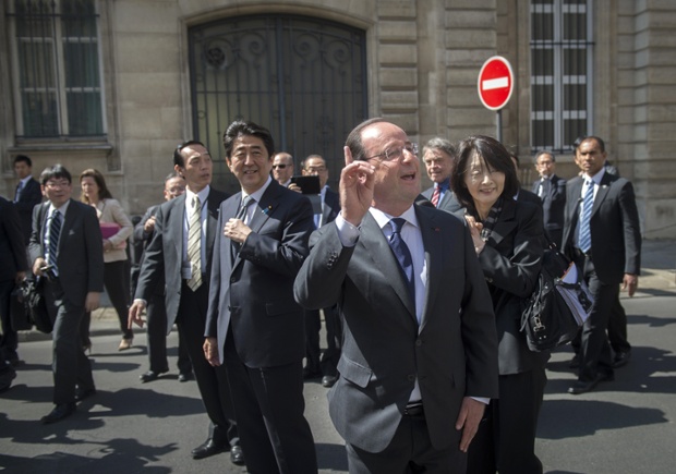Tổng thống Pháp Francois Hollande chào những người ủng hộ  khi ông rời Cung điện Elysee ở Paris cùng với Thủ tướng Nhật Bản Shinzo Abe.
