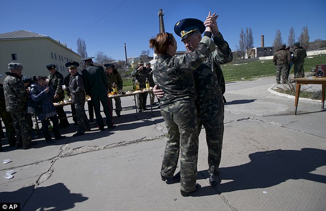 Earlier in the day: Two members of the Ukrainian air force dance as they celebrate a comrades wedding