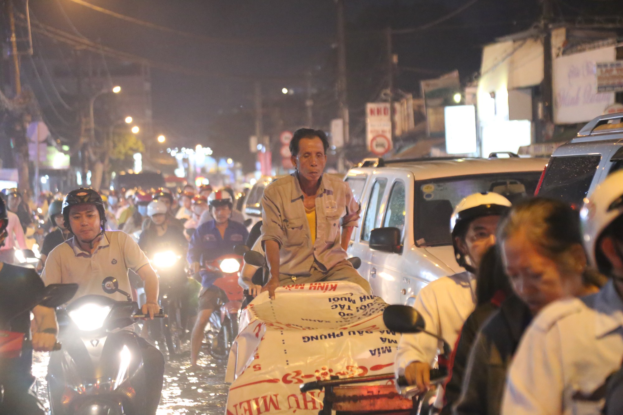 Sài Gòn ùn tắc kinh hoàng sau mưa lớn, trẻ em ngủ gục trên vai ba mẹ ngoài đường - Ảnh 1.