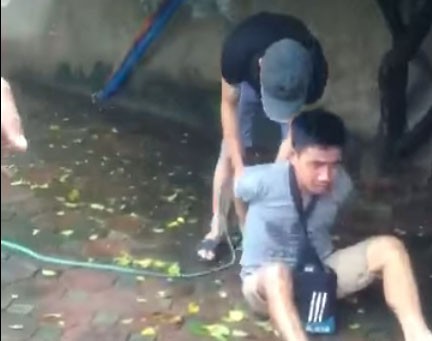 Hai người đàn ông trói tay, hành hung nam thanh niên giữa phố Hà Nội vì nghi trộm xe - Ảnh 1.