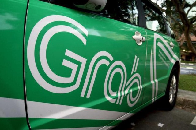 Grab đối đầu Taxi truyền thống tại Việt Nam: Ai hưởng lợi? - Ảnh 1.