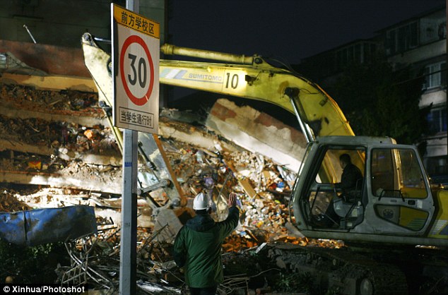 Keep going: The search for any trapped victims will continue through the night in Ningbo City