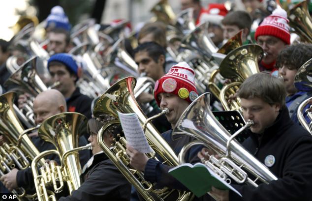 Musicians play brass instruments for the 35th Annual Dallas Merry Tubachristmas Concert at Thanks-Giving Square in downtown Dallas