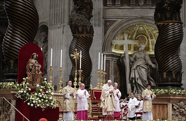 Pope Benedict XVI prays as he leads the Christmas night mass in the Saint Peter's Basilica at the Vatican