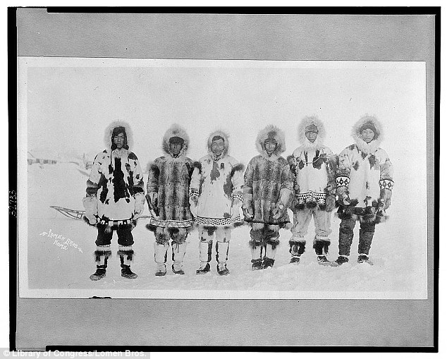 Withstanding: A line of Eskimo men are pictured between 1900 and 1930 while wearing various shades and patterns of animal furs as protection