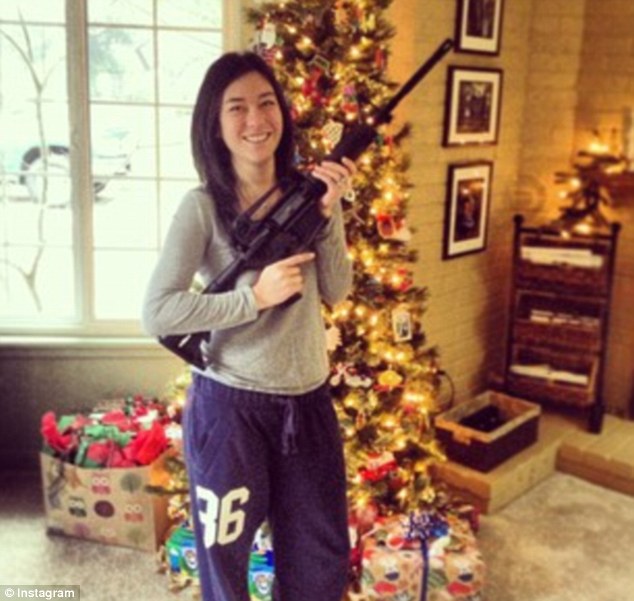 Packing heat: Numerous Americans were seen on social networks posing in front of their Christmas trees with the same assault rifle used by the gunmen in three recent bloody killings
